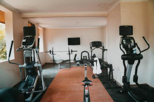 a gym with tread machines in a room at Airport Planet Lodge in Kingori