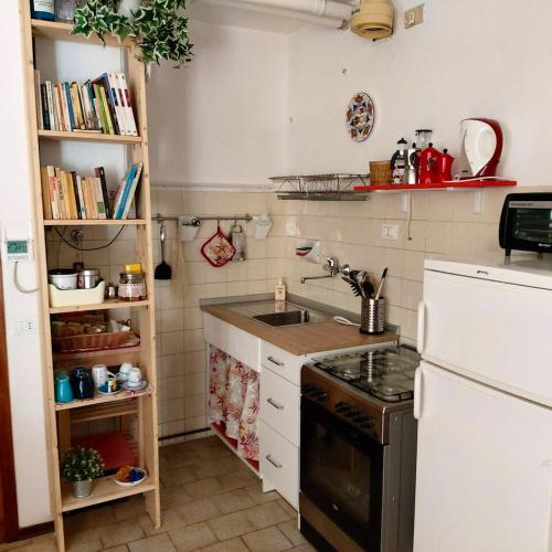 a small kitchen with a sink and a stove at One bedroom apartement at Marina di Ravenna 400 m away from the beach with enclosed garden and wifi in Marina di Ravenna