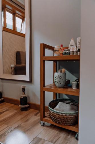a room with a shelf with dishes and a mirror at Airport Planet Lodge in Kingori