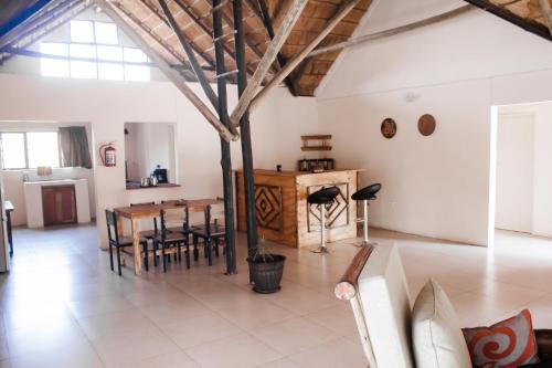 a large living room with a table and chairs at Leeville Guesthouse in Kasane
