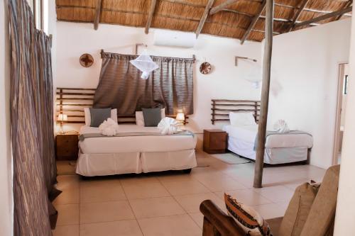 a bedroom with two beds in a room at Leeville Guesthouse in Kasane