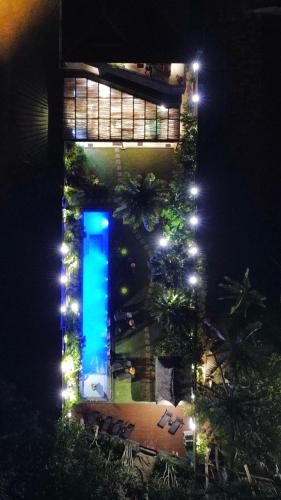 a building with a blue light in front of it at night at Pousada TeMoana in Ubatuba