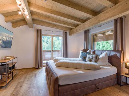 a bedroom with a large bed and two windows at Ferienhaus Paula in Going