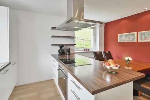 a kitchen with a counter and a bowl of fruit at Apartmenthaus Steiner in Lech am Arlberg