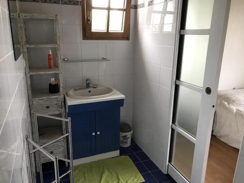 a small bathroom with a sink and a mirror at Longère - 10 personnes - Vue mer in Tréguennec