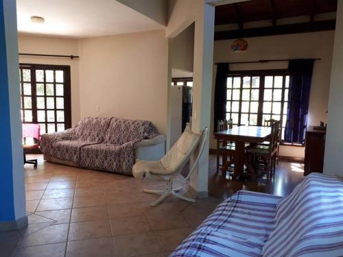 a bedroom with a bed and a table and chairs at Pousada Casa Natuco in Chapada dos Guimarães