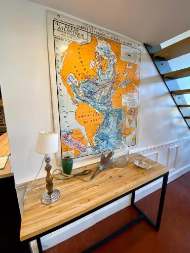 a table with a map on the wall at Les Suites du Cours & Spa in Aix-en-Provence