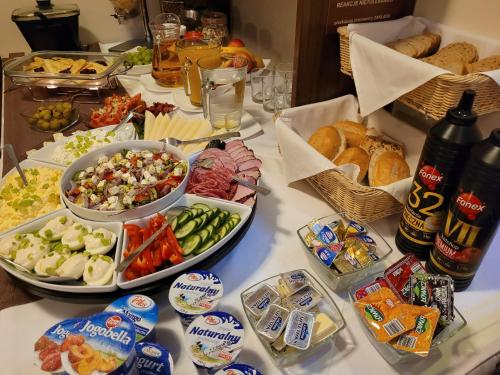 a buffet with different types of food on a table at Hotel Mieszko in Rzeszów