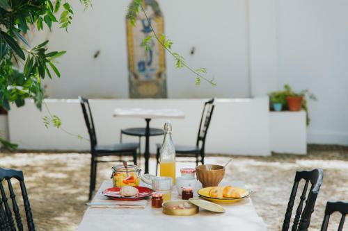 a table with food and a bottle of orange juice at Senhora do Cabo Meco Homy Holidays in Sesimbra
