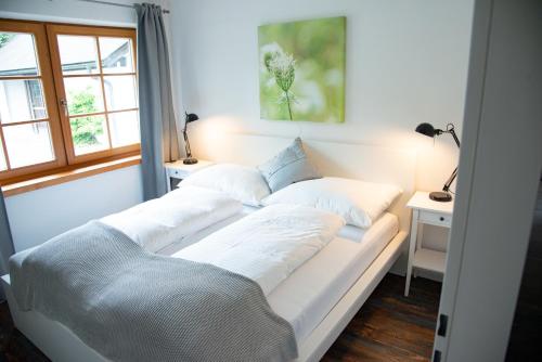 a white couch in a room with a window at Seehof direkt am See mit privatem Seezugang 