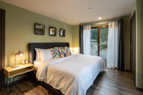 a bedroom with a large bed and a window at Gated Community Home, Parking, Pool, Tennis court in San Miguel de Allende