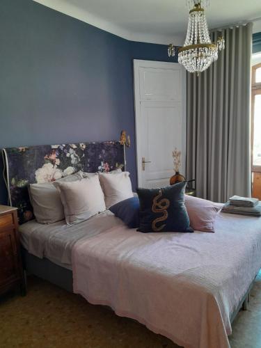 a bedroom with a large bed with a blue wall at Ballerina Bianca bed & breakfast in Grottazzolina