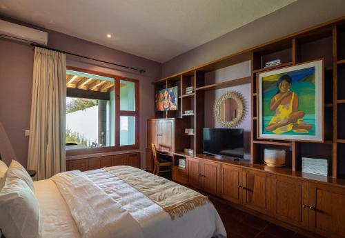 a bedroom with a bed and a television in it at Charming Villa for Weddings, Stunning Views in San Miguel de Allende