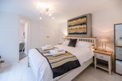 a bedroom with a large bed with two pillows on it at The Apartment at Clare House, Aldeburgh in Aldeburgh