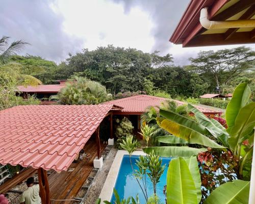 a view of a house with a swimming pool at The Inner Light Yoga Lodge in Sámara