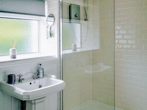 a bathroom with a sink and a shower at Holmbyre Smithy in Dalry