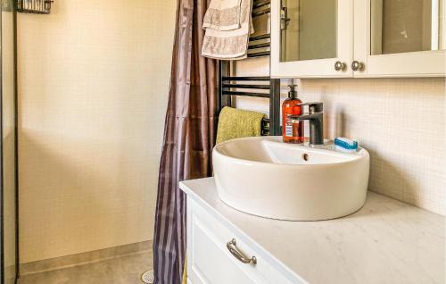 a bathroom with a white sink and a shower at 2 Bedroom Beautiful Home In Annerstad in Annerstad