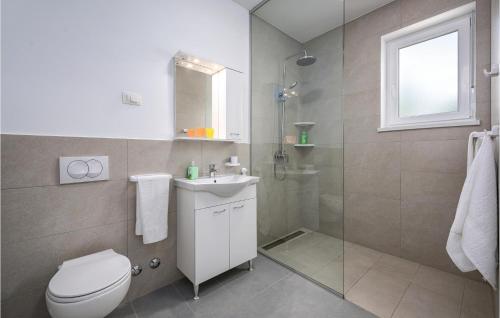a bathroom with a toilet and a sink and a shower at Lovely Home In Zminj With Kitchen in Žminj
