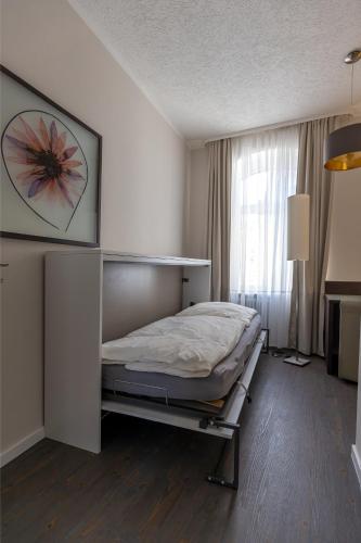 a bedroom with a bed in a room with a window at Hotel Garni " Am Domplatz" in Erfurt