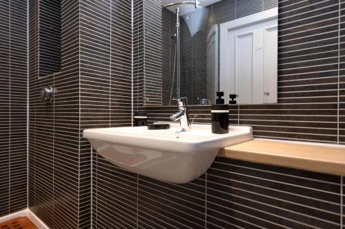 a bathroom with a sink and a mirror at ALTIDO Stylish 2-bed flat in New Town in Edinburgh