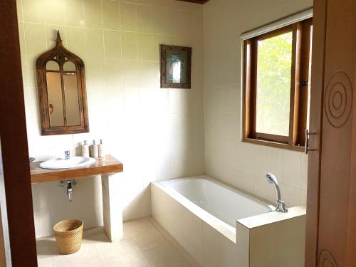a bathroom with a bath tub and a sink at Villa Agung Khalia Ubud in Ubud
