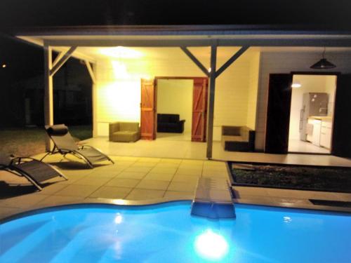 a view of a swimming pool at night at "Villa confortable proche de Case-Pilote avec piscine privée" in Case-Pilote