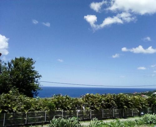 a view of the ocean from a house at "Villa confortable proche de Case-Pilote avec piscine privée" in Case-Pilote