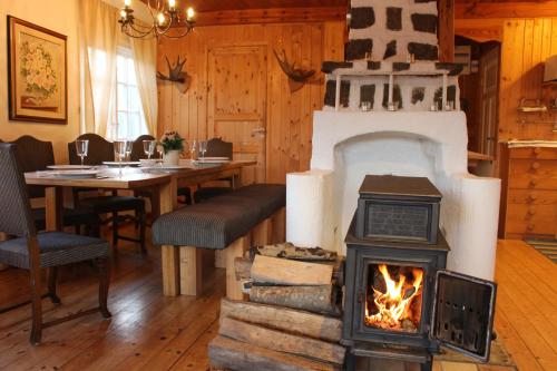 a fireplace in a living room with a stove at Landhouse in Olofström
