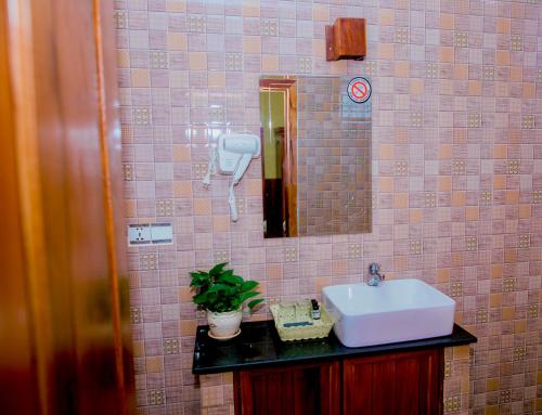 a bathroom with a sink and a mirror at Mohasal Angkor Boutique in Siem Reap