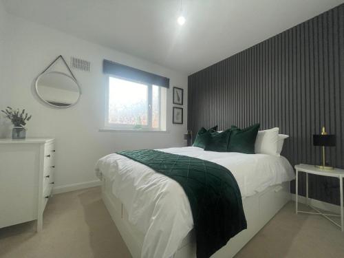 a bedroom with a large bed and a window at Grand Station Suite in Wolverhampton