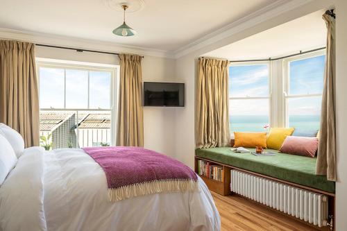 a bedroom with a window seat with a view of the ocean at Fort Road Hotel in Margate