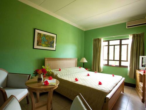 a bedroom with a bed with red hearts on it at Gregoire's Apartment in La Digue