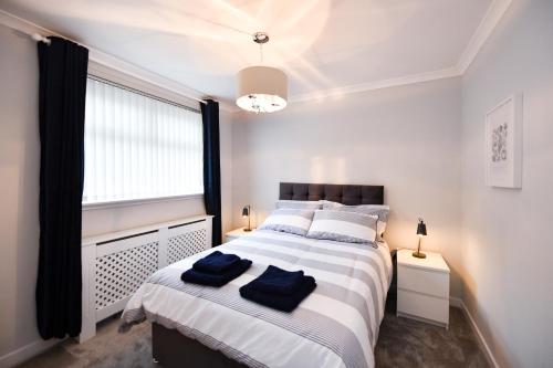 a bedroom with a large bed and a window at Sea Star in Troon