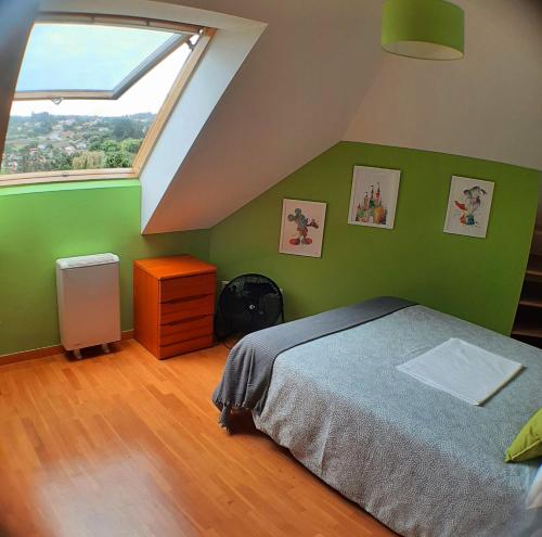 a green bedroom with a bed and a window at Cozy & Quiet Apartment. in Sada