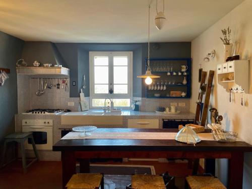 a kitchen with a table and a sink at la casina nel tempo in Santarcangelo di Romagna