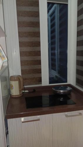 a kitchen with a counter top with a window at Мтко-1 in Khujand