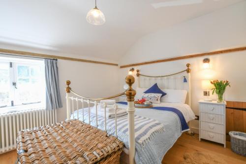 a bedroom with a bed and a window at Flaxen Cottage, Heveningham in Heveningham