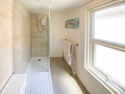 a bathroom with a shower and a window at The Terrace in Great Yarmouth