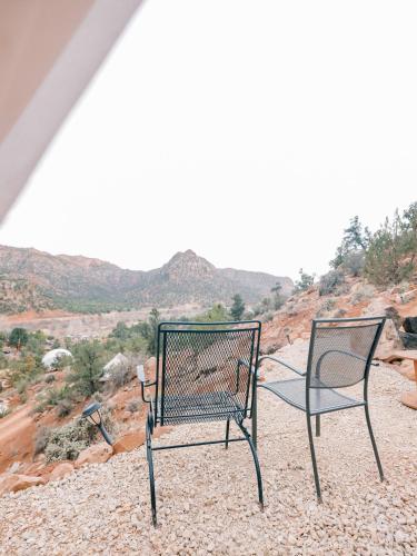 two chairs sitting on top of a rocky hill at Zion Glamping Adventures in Hildale