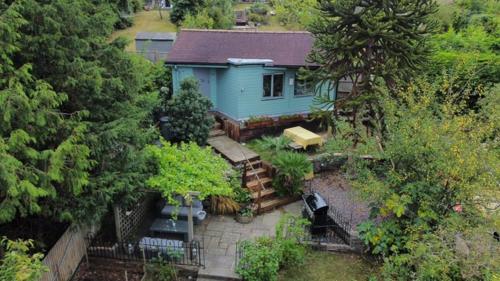 an aerial view of a blue house with trees at Greenfield Lodge in Brighton & Hove