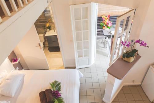 a view of a room with a bed and a staircase at Ilet du Lagon in La Saline les Bains