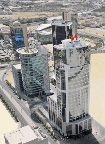 an aerial view of a city with tall buildings at Swiss-Belhotel Seef Bahrain in Manama