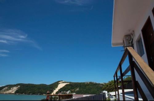 a balcony of a building with a view of the ocean at Encanto da Praia hotel pousada in Natal