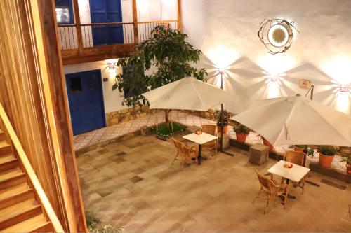 an overhead view of a patio with tables and umbrellas at Quinta San Blas by Ananay Hotels in Cusco