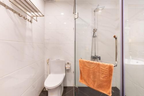 a bathroom with a toilet and a shower at Silk Hong Ha airport hotel in Ho Chi Minh City