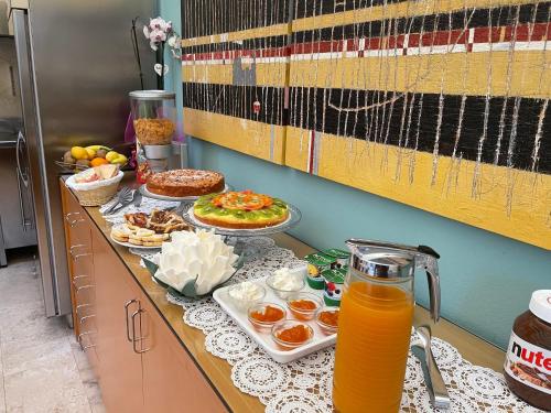 a table with food and a jug of orange juice at Hotel Poggio Bertino in Montemerano