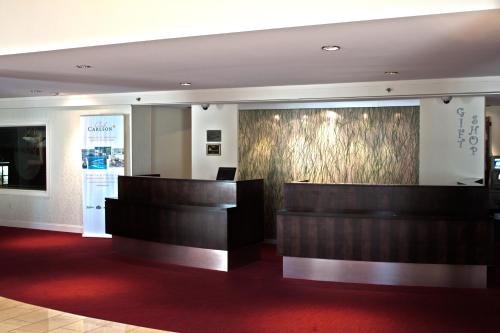 a lobby of a hotel with a reception desk at Penn Harris Hotel Harrisburg, Trademark by Wyndham in Harrisburg