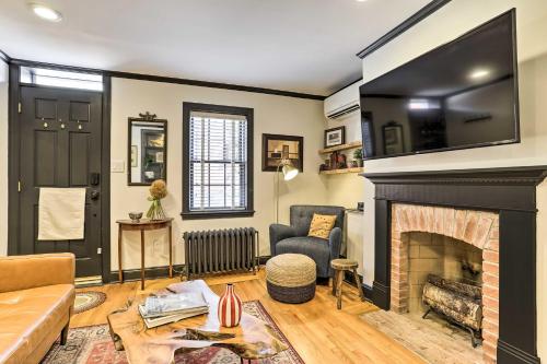 a living room with a fireplace and a couch at Historic Home with Garden, 4 Mi to World Cup Matches in Philadelphia
