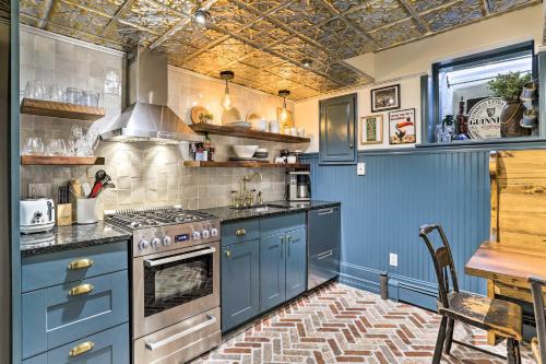 a blue kitchen with a stove and a table at Historic Home with Garden, 4 Mi to World Cup Matches in Philadelphia