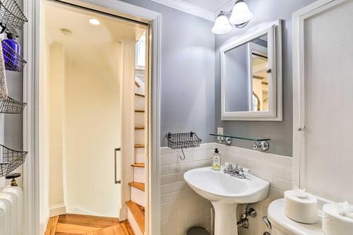 a white bathroom with a sink and a mirror at Historic Home with Garden Walk to Center City! in Philadelphia